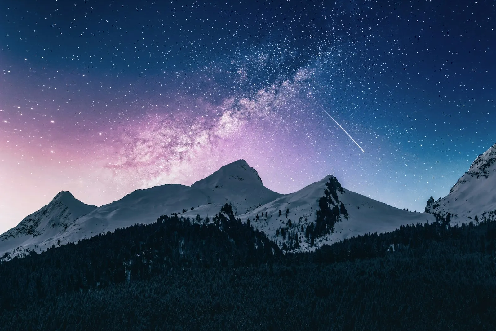 Snow-capped mountain peaks at dusk