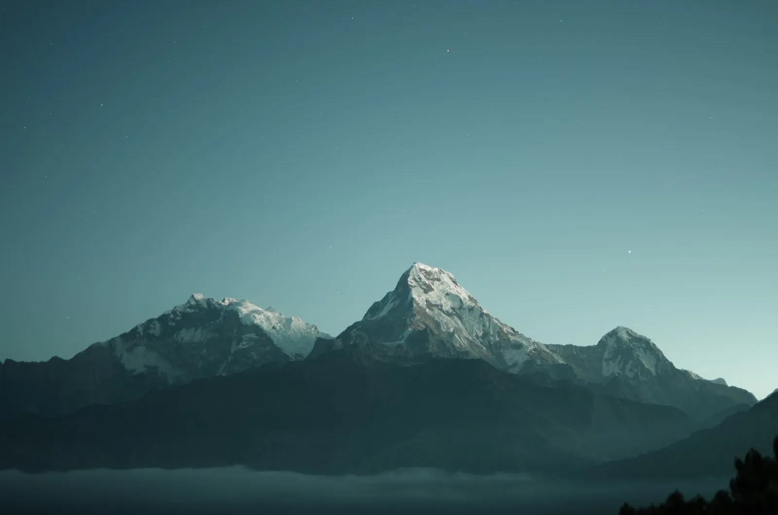 Snowy peaks under a starry night sky